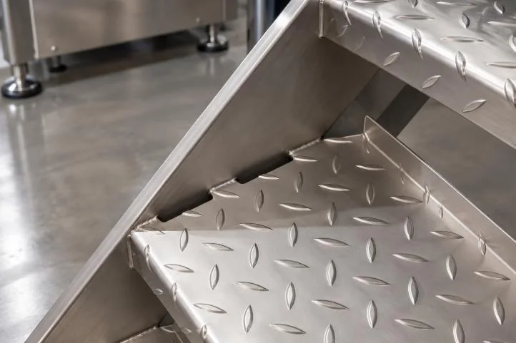 Checker-plate stair treads and welded side support detail